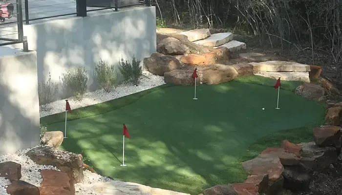 Turf installed for a mini putting area in backyard.