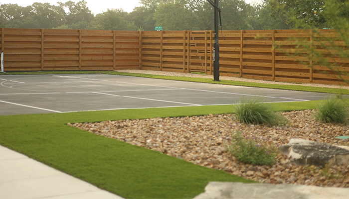 Blacktop for basketball with landscaping.
