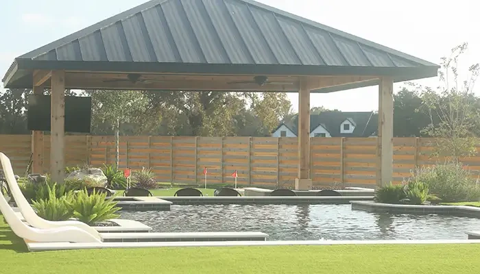 Cozy outdoor living space with covered sitting space and pool.