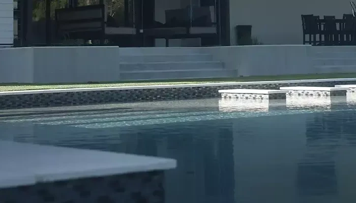 Pool maintenance with large pool in back ground.