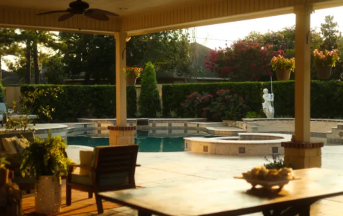 Backyard patio and water feature ideas with pool, covered seating, and summer landscaping