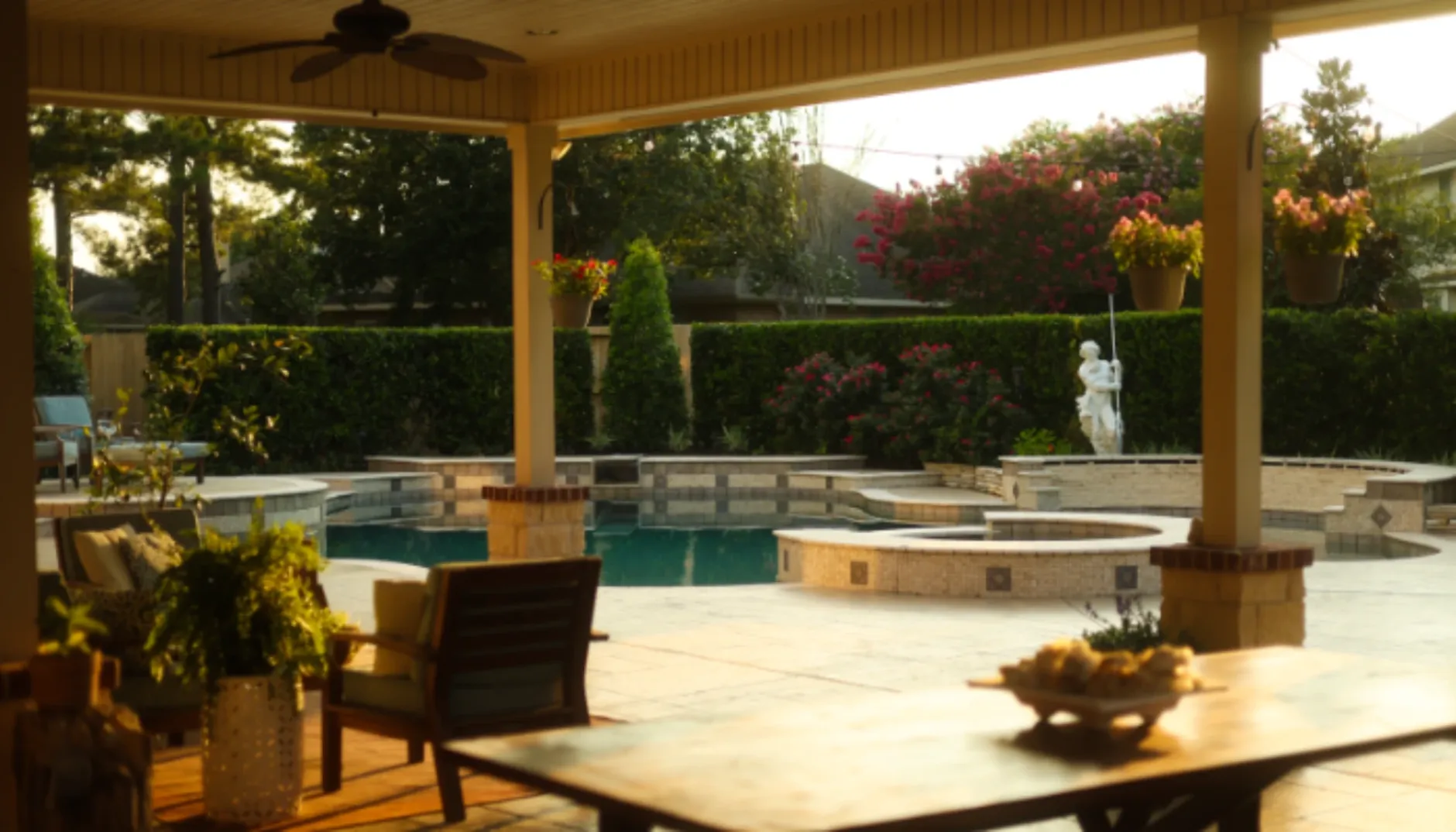 Backyard patio and water feature ideas with pool, covered seating, and summer landscaping